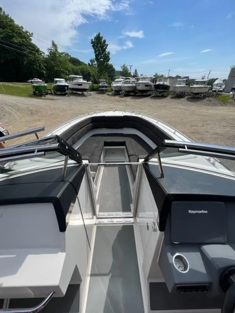 Slide: The Image of 2016 Draco 27 RS boat interior with view of bow and docked boats. - 18