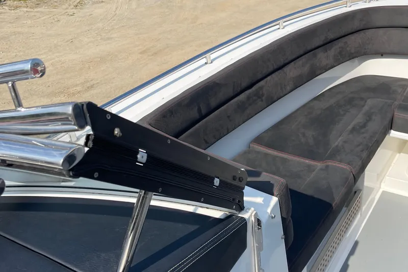 Slide: The Image of 2016 Draco 27 RS boat with black cushioned seating and stainless steel railings. - 19