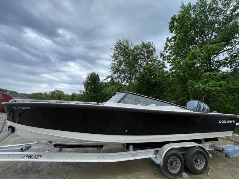 Slide: The Image of 2016 Draco 27 RS boat on a Load Rite trailer, parked outdoors. - 2