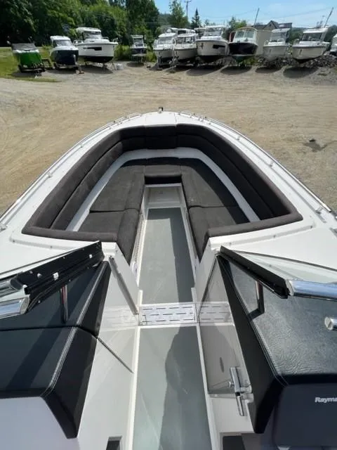 Slide: The Image of 2016 Draco 27 RS boat with spacious seating and open deck, docked in a boatyard. - 20