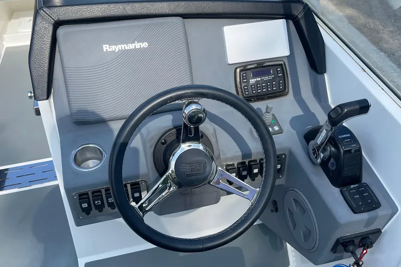 Slide: The Image of Draco 27 RS 2016 boat dashboard with Raymarine navigation system and steering wheel. - 24