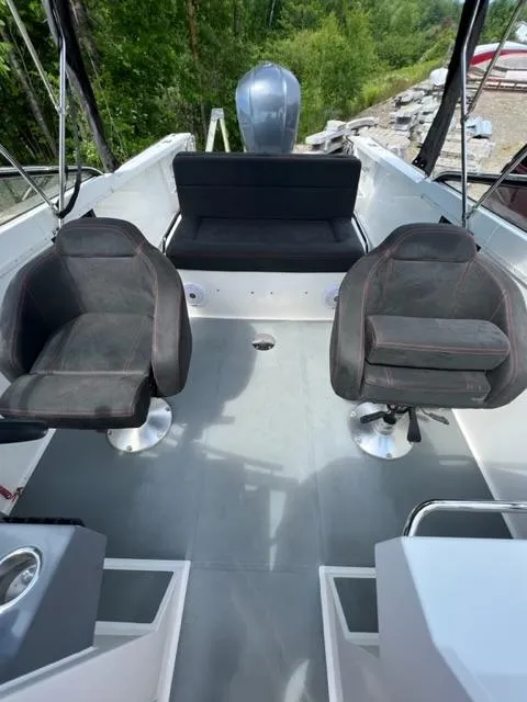 Slide: The Image of Interior of a 2016 Draco 27 RS boat with seating and steering area. - 26