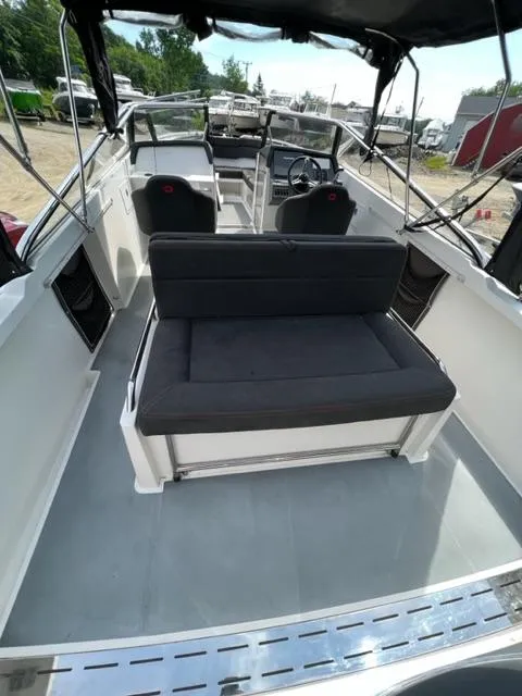 Slide: The Image of 2016 Draco 27 RS boat interior with seating and steering console. - 27