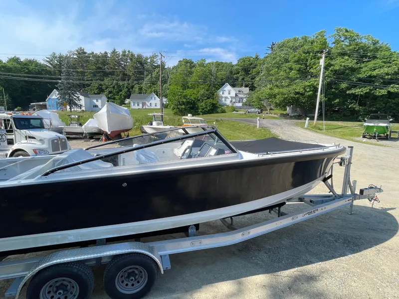 Slide: The Image of 2016 Draco 27 RS boat on a trailer in a sunny outdoor setting. - 3