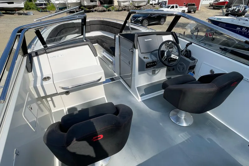 Slide: The Image of 2016 Draco 27 RS boat interior with steering console and seating. - 31