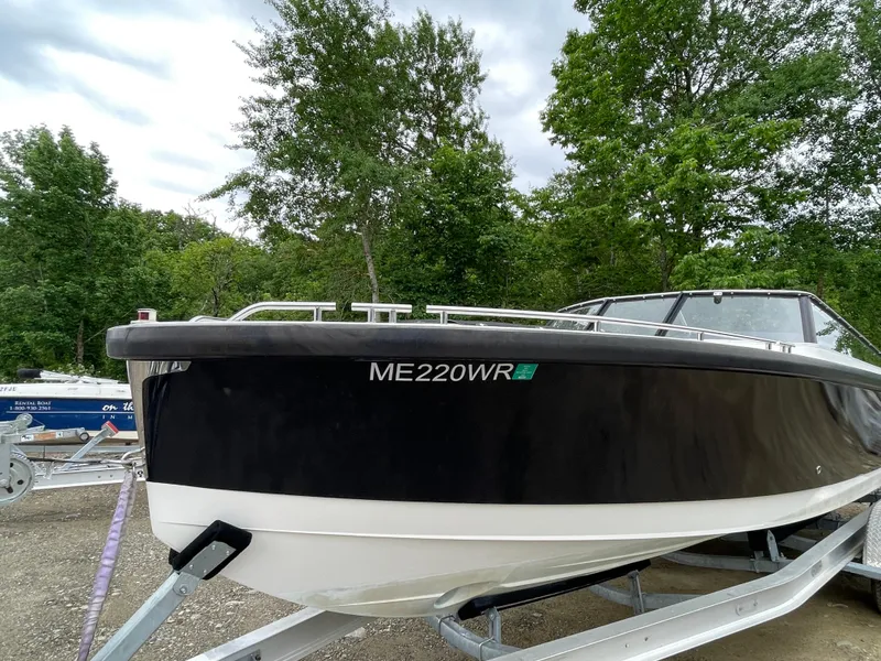 Slide: The Image of 2016 Draco 27 RS boat on trailer, black and white hull, registration ME220WR. - 4