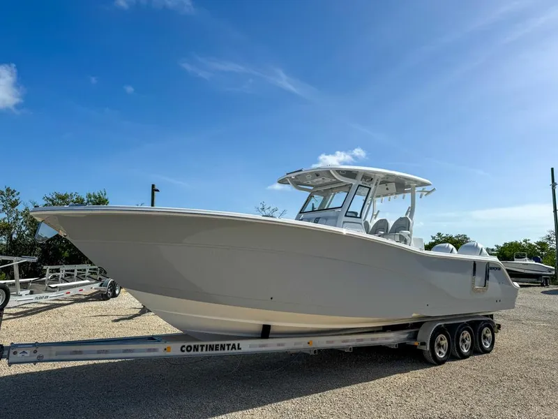 Slide: The Image of 2025 Sea Fox 328 Commander boat on trailer, parked outdoors under clear blue sky. - 0