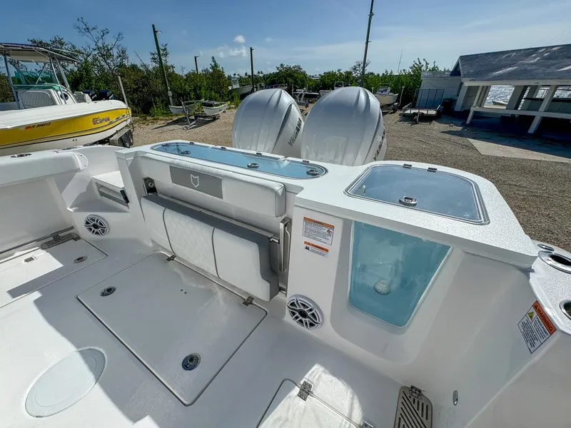 Slide: The Image of 2025 Sea Fox 328 Commander boat deck with dual engines and storage compartments. - 10