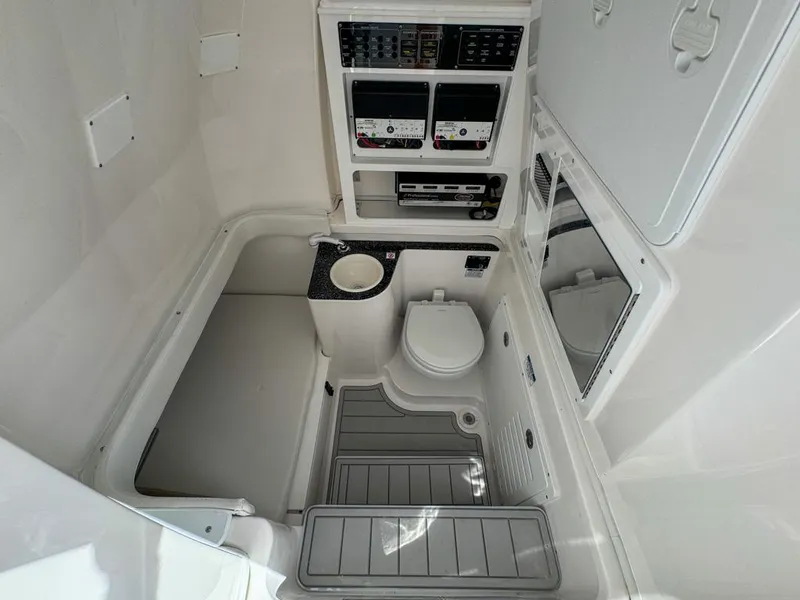 Slide: The Image of 2025 Sea Fox 328 Commander boat interior with toilet, sink, and control panels. - 25