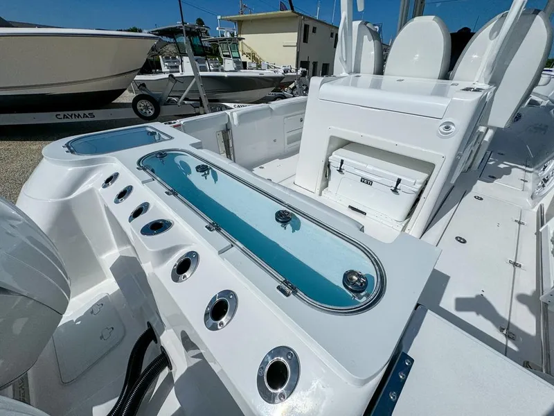 Slide: The Image of 2025 Sea Fox 328 Commander boat interior with fishing rod holders and livewell. - 9