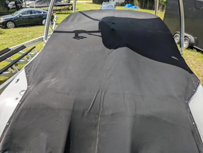 Slide: The Image of 2012 Four Winns F244 boat with black cover on trailer. - 12
