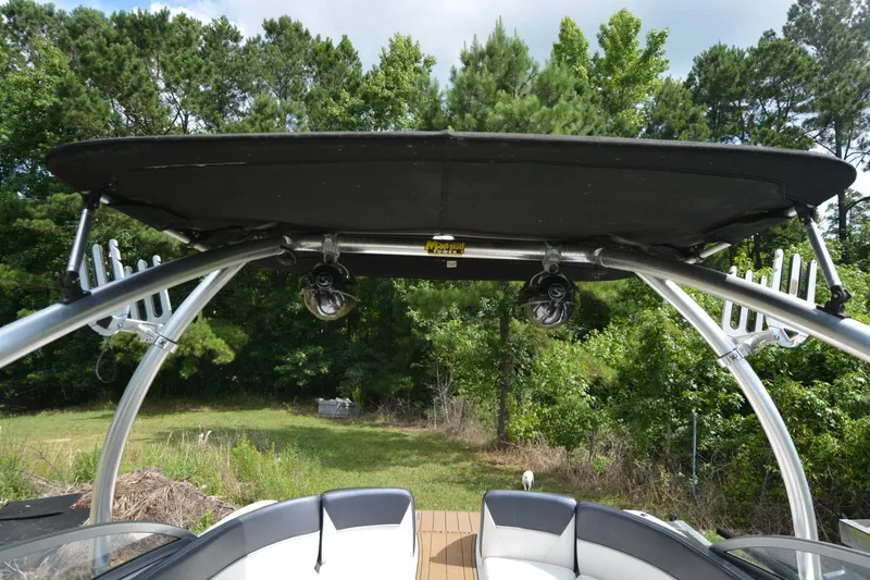 Slide: The Image of 2012 Four Winns F244 boat with a black bimini top and wakeboard tower. - 14