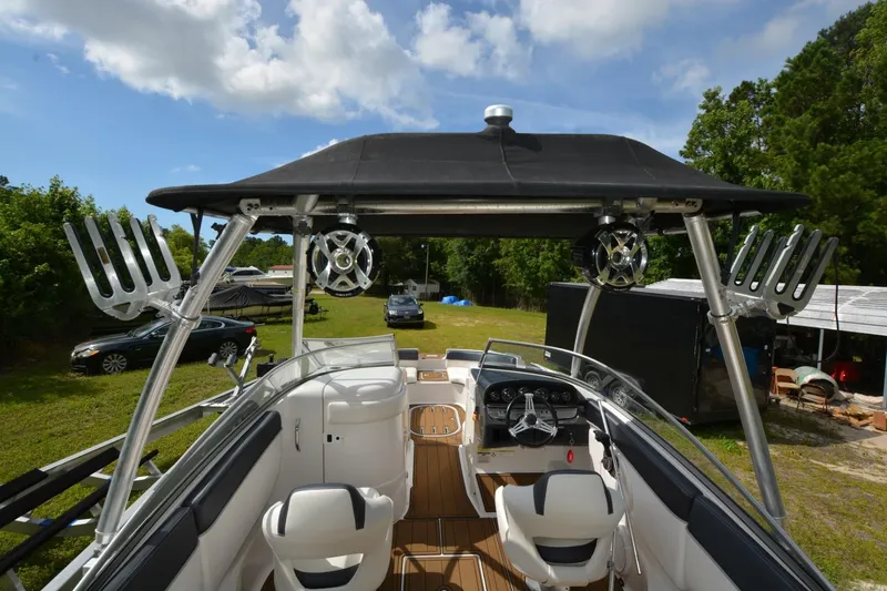 Slide: The Image of 2012 Four Winns F244 boat interior with black canopy and white seating. - 15