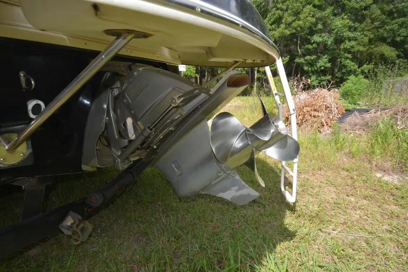 Slide: The Image of 2012 Four Winns F244 boat propeller and stern drive on grassy area. - 22