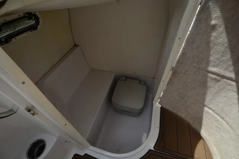Slide: The Image of 2012 Four Winns F244 boat interior with compact toilet. - 8