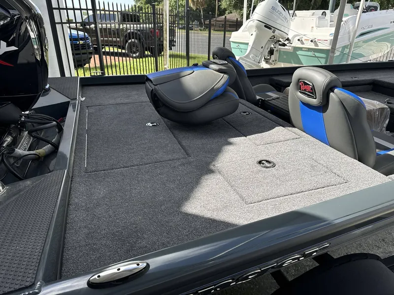 Slide: The Image of 2024 Ranger 178 boat interior with gray carpeted deck and blue-accented seats. - 4
