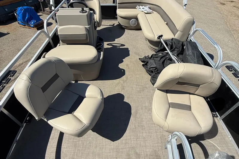 Slide: The Image of 2022 Sun Tracker Bass Buggy 16 XL Select pontoon boat interior with beige seating. - 6