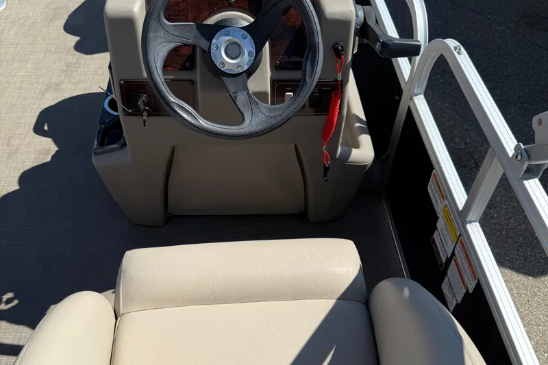 Slide: The Image of 2022 Sun Tracker Bass Buggy 16 XL Select steering console with beige seating. - 7