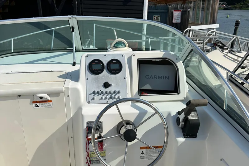 Slide: The Image of 2004 Hydra-Sports 230 WA boat dashboard with Garmin navigation system and steering wheel. - 3