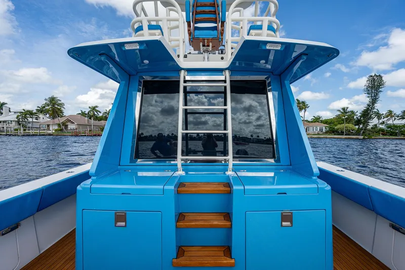 Slide: The Image of 2021 Gulf Crosser 52 yacht with blue exterior and ladder on deck. - 29