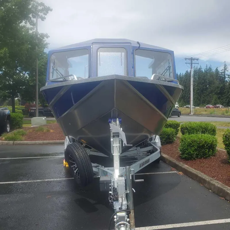 Slide: The Image of 2024 Spartan 215 Athens boat on a trailer in a parking lot. - 4