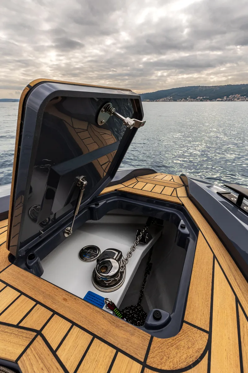 Slide: The Image of 2026 SuperRib Open 27 boat with open storage compartment on a calm sea. - 10