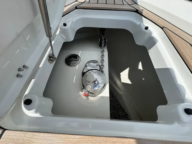 Slide: The Image of Anchor storage compartment of 2025 SuperRib Open 27 boat with chain and winch. - 30