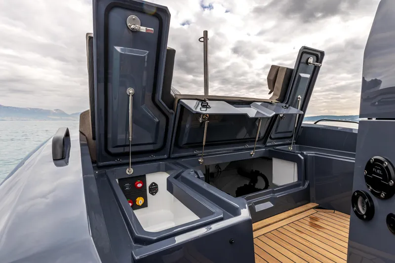 Slide: The Image of 2026 SuperRib Open 27 boat interior with open storage compartments and wooden deck. - 6