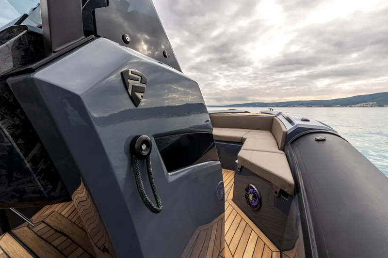 Slide: The Image of 2026 SuperRib Open 27 boat with sleek design, luxury seating, and modern features on calm water. - 8