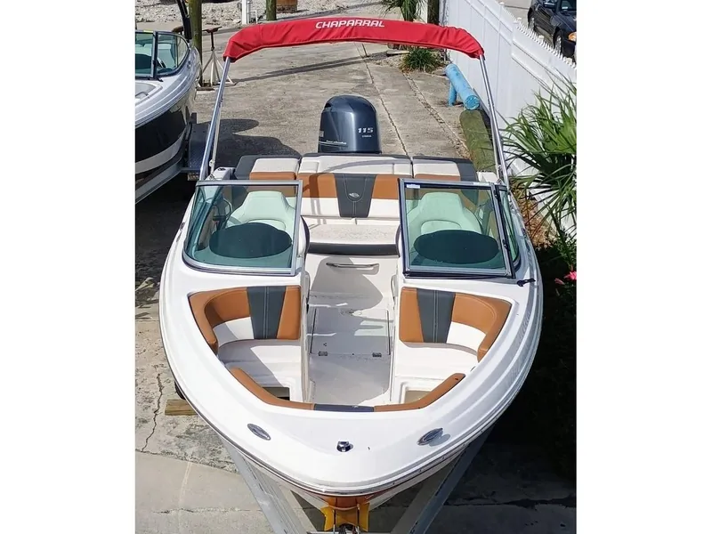Slide: The Image of 2024 Chaparral 19 SSi OB boat with red canopy and stylish seating. - 1