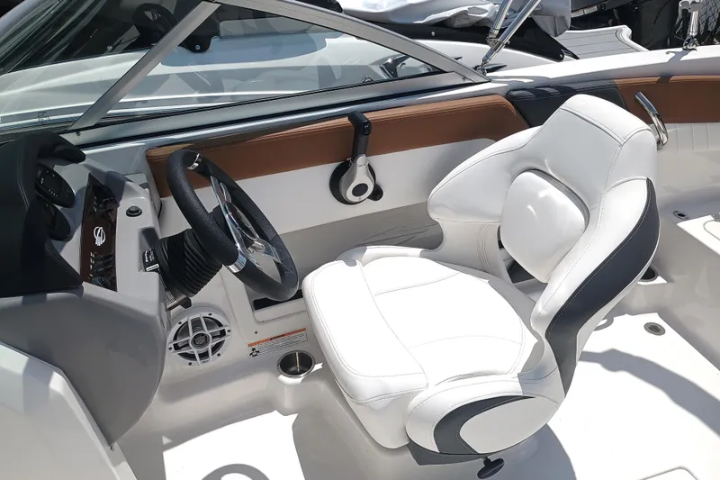 Slide: The Image of 2024 Chaparral 19 SSi OB boat interior with white seating and modern dashboard. - 10