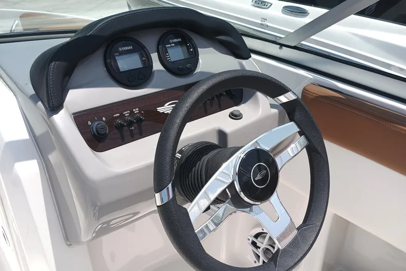 Slide: The Image of 2024 Chaparral 19 SSi OB boat dashboard with steering wheel and gauges. - 11