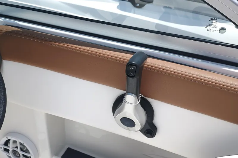 Slide: The Image of 2024 Chaparral 19 SSi OB boat interior with control lever and speaker detail. - 12