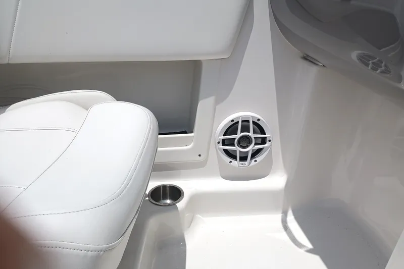 Slide: The Image of 2024 Chaparral 19 SSi OB interior with white seating and speaker detail. - 15