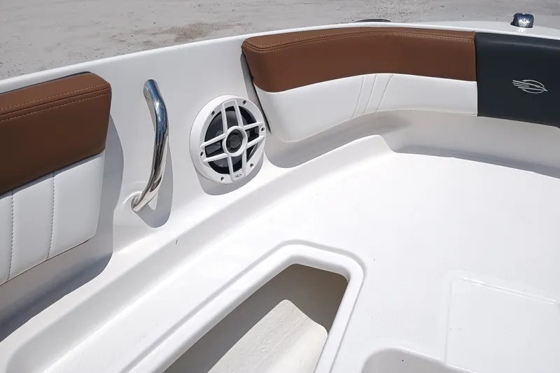 Slide: The Image of 2024 Chaparral 19 SSi OB boat interior with brown seating and speaker. - 17
