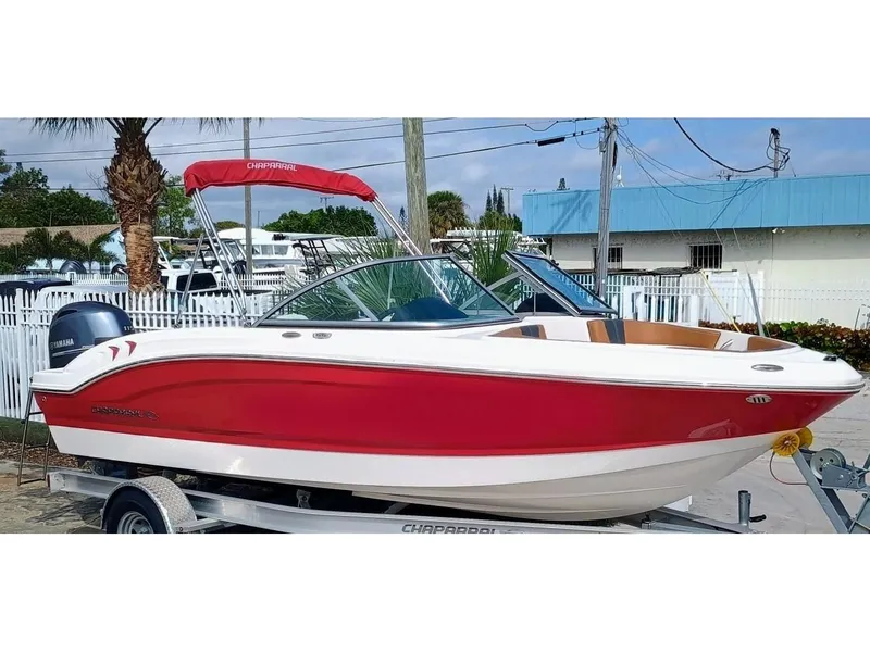 Slide: The Image of 2024 Chaparral 19 SSi OB boat with red and white exterior on a trailer. - 3