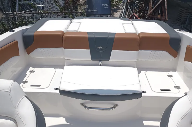 Slide: The Image of 2024 Chaparral 19 SSi OB boat interior with cushioned seating and storage compartments. - 6