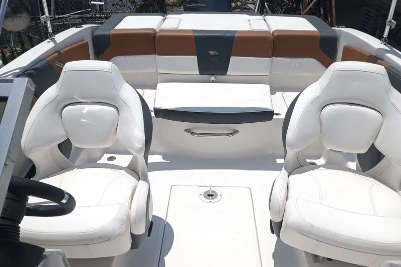 Slide: The Image of 2024 Chaparral 19 SSi OB boat interior with white seating and modern design. - 7