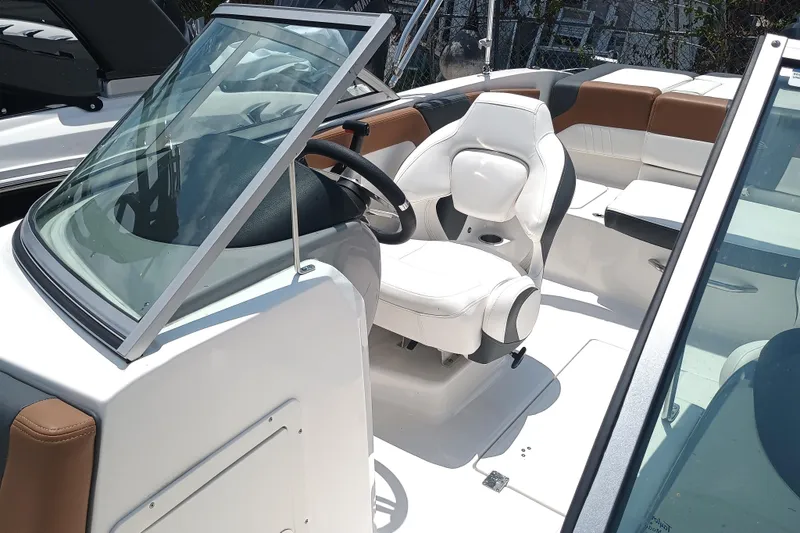 Slide: The Image of 2024 Chaparral 19 SSi OB boat interior with white and brown seating. - 8