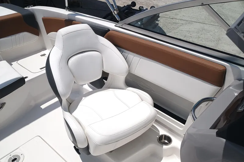 Slide: The Image of 2024 Chaparral 19 SSi OB boat interior with white cushioned seat and brown accents. - 9