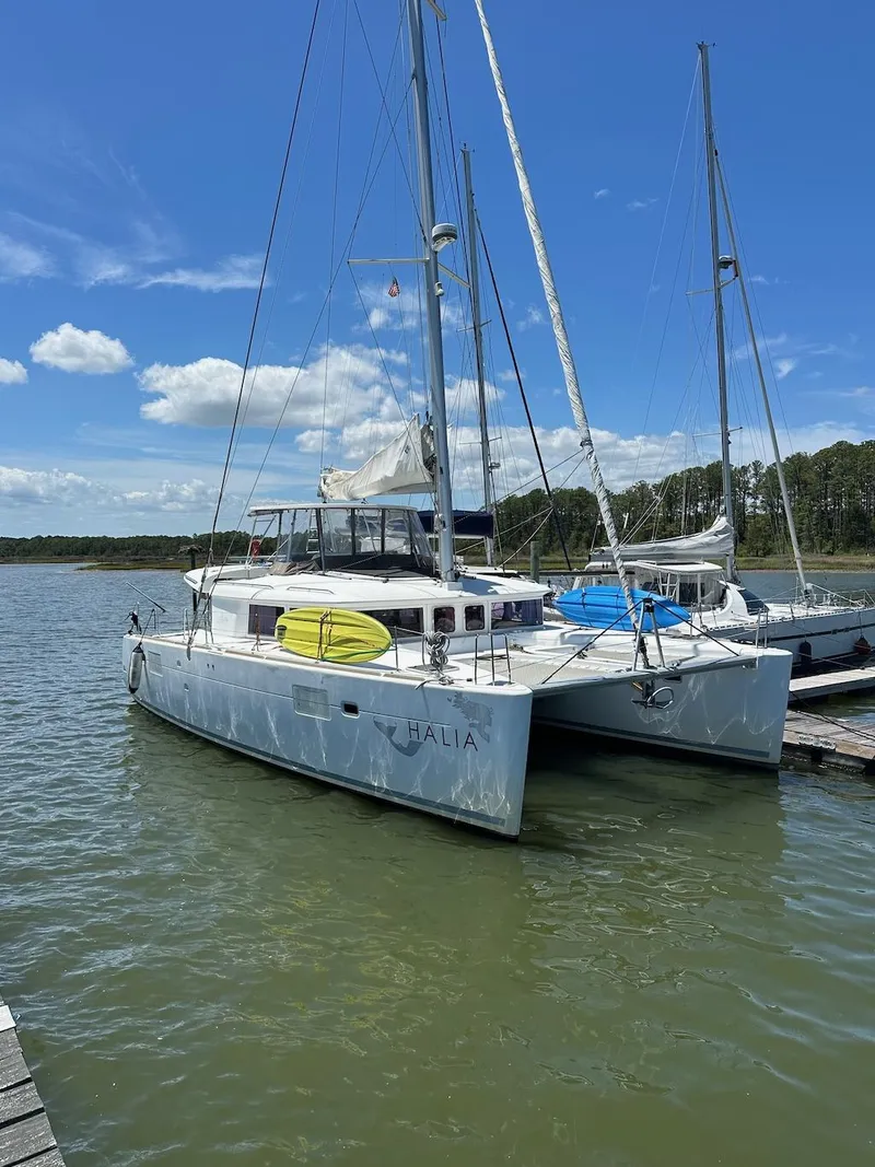 The Image of 2014 Lagoon 450 catamaran docked on a sunny day with clear skies. - 0
