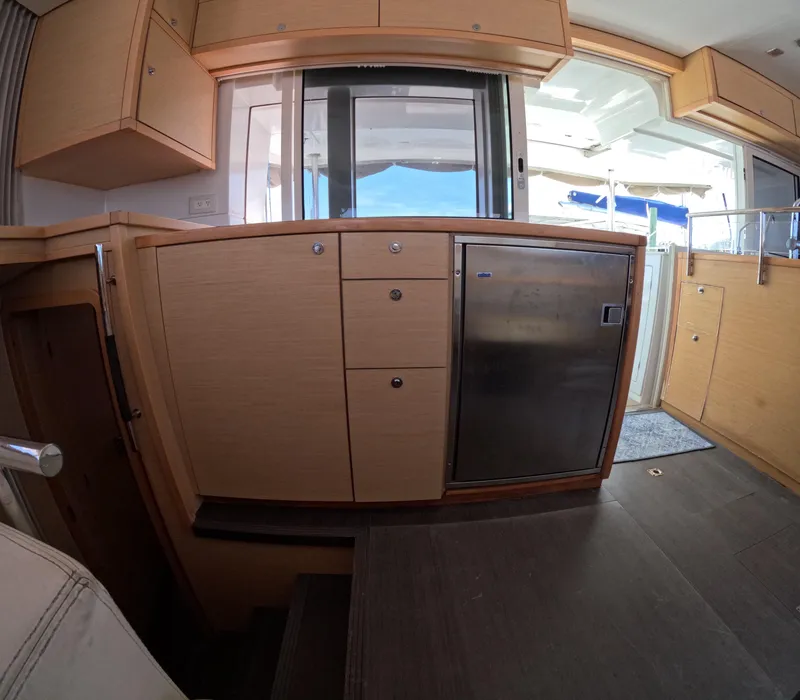 Slide: The Image of Interior of 2014 Lagoon 450 yacht with modern kitchen cabinetry and stainless steel appliances. - 13