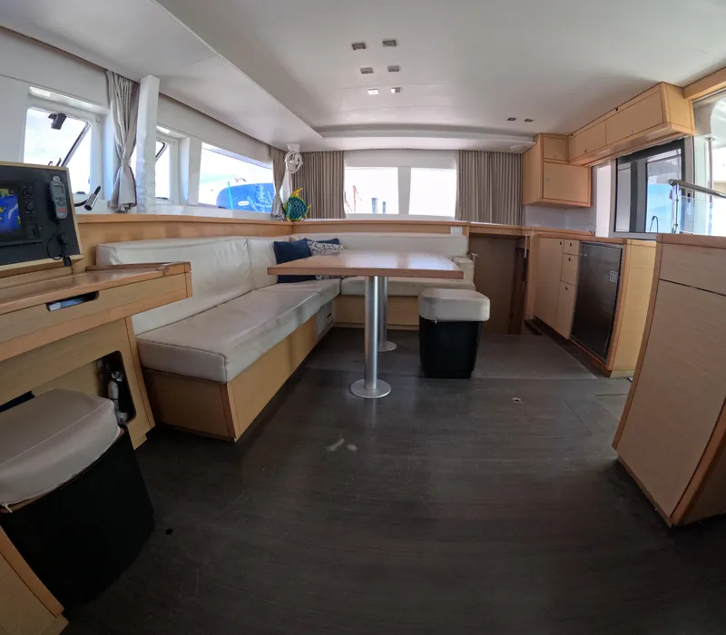 Slide: The Image of Interior of 2014 Lagoon 450 catamaran with modern seating and kitchen area. - 17