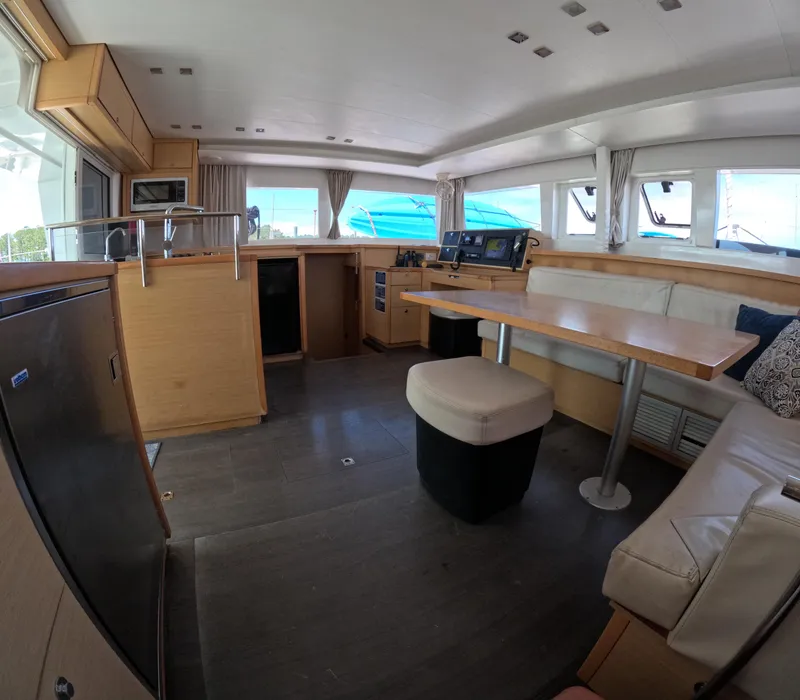 Slide: The Image of Interior of a 2014 Lagoon 450 catamaran with modern furnishings and navigation equipment. - 18