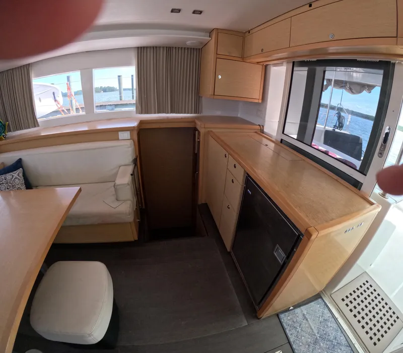 Slide: The Image of Interior of 2014 Lagoon 450 catamaran with wooden cabinetry and seating area. - 20