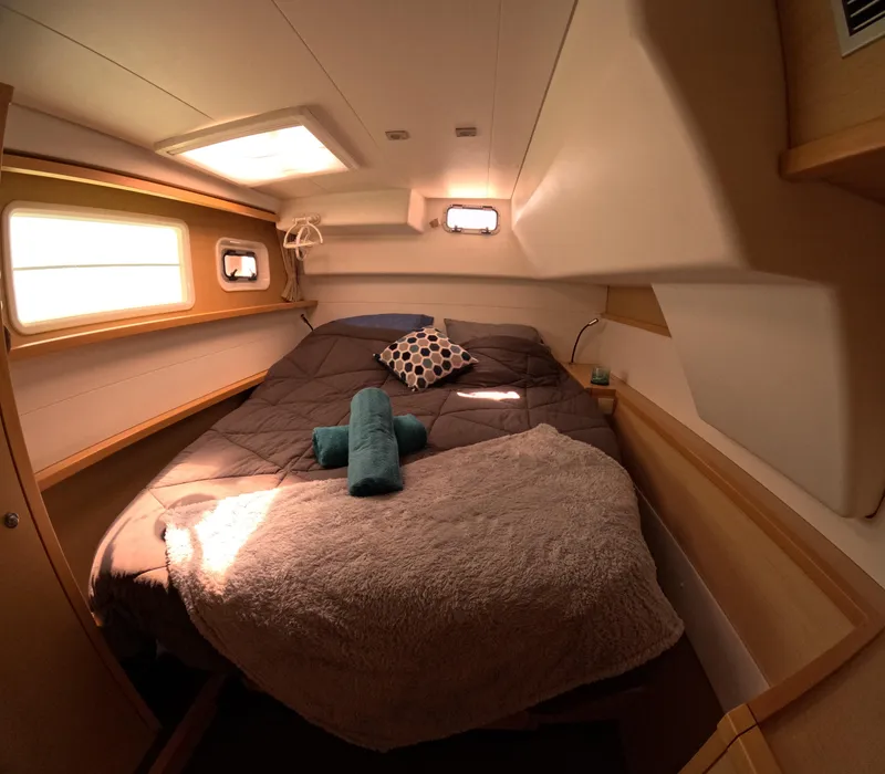 Slide: The Image of Cozy cabin interior of 2014 Lagoon 450 catamaran with bed and porthole windows. - 21