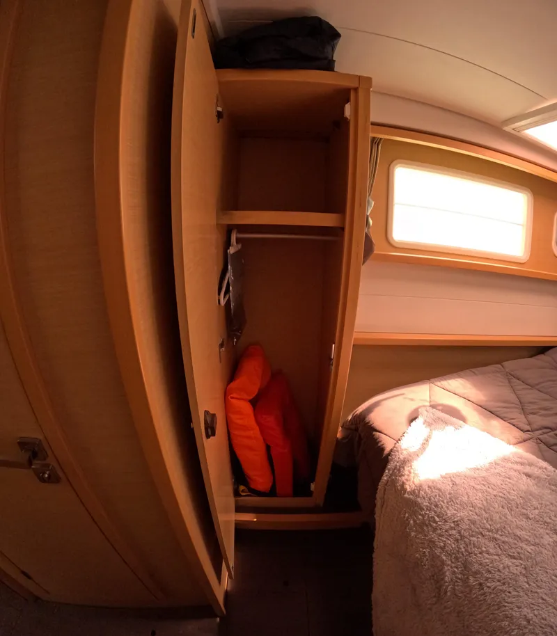 Slide: The Image of Interior of 2014 Lagoon 450 yacht cabin with wooden wardrobe and bed. - 22