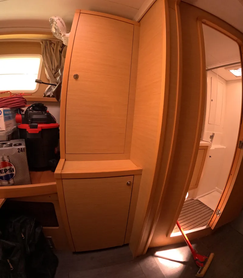 Slide: The Image of Interior of 2014 Lagoon 450 yacht with wooden cabinets and adjacent bathroom. - 24