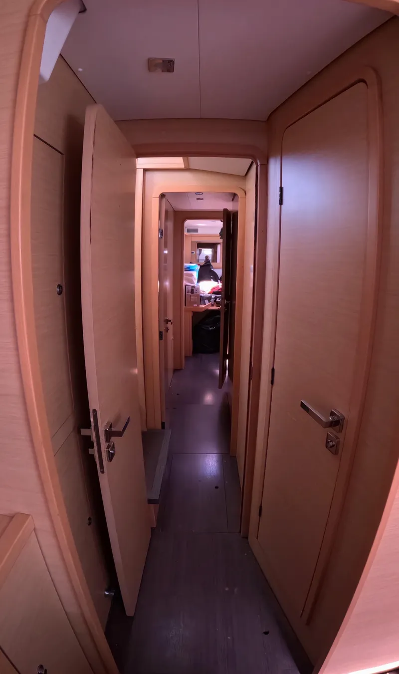 Slide: The Image of Interior hallway of a 2014 Lagoon 450 catamaran with wooden doors. - 28