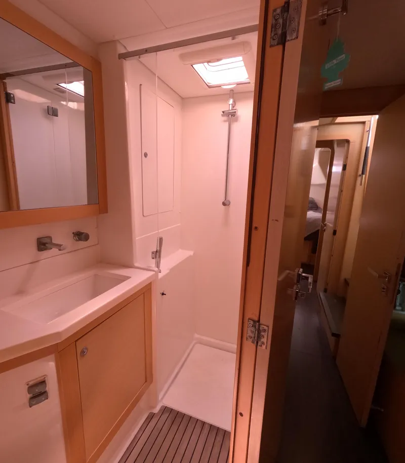 Slide: The Image of 2014 Lagoon 450 yacht bathroom with shower, sink, and mirror. - 29